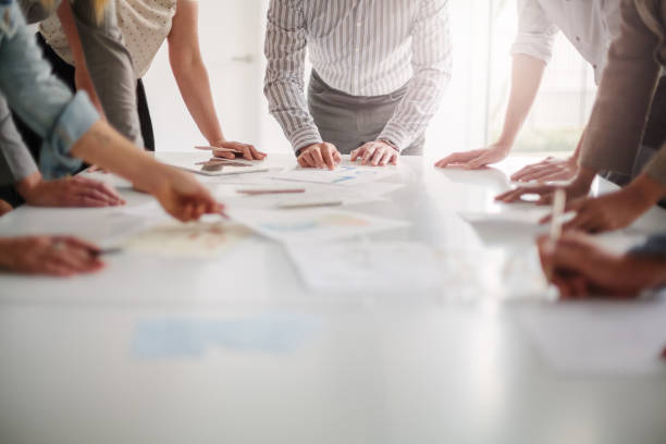 Professional workspace with team reviewing organizational documents